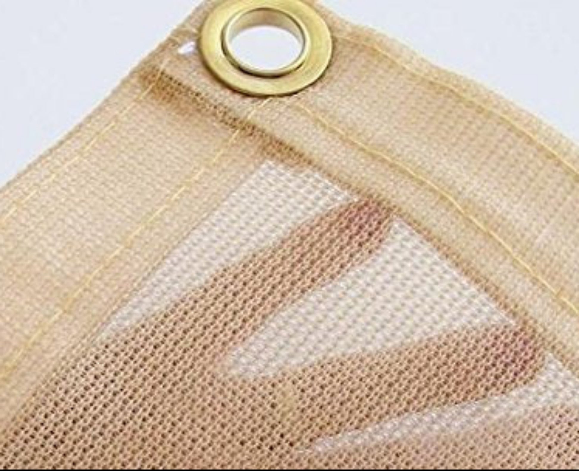 Close-up of breathable mesh tarp material showing weave pattern reinforced edge and grommet